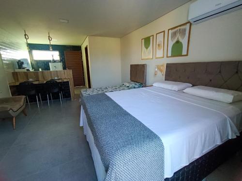 a bedroom with a large white bed in a room at Flats Marina Maragogi in Maragogi