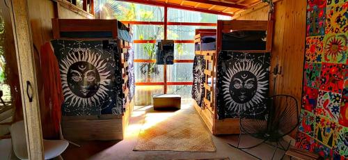 a room with a door with faces painted on it at La Sardina in Todos Santos