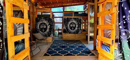 a room with wooden bunk beds and a blue rug at La Sardina in Todos Santos