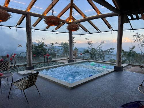 a pool in a building with a view of the mountains at Eucaliptus Spa Resort in Dapa