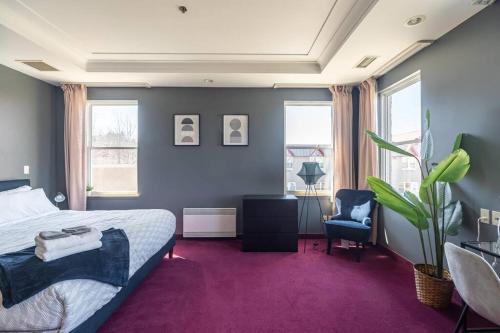 a bedroom with a bed and a purple carpet at Urban Nest, 1-BDRM Apt in Halifax