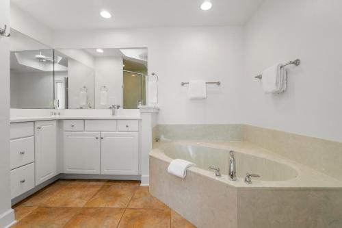 a large bathroom with a large tub and a sink at Destin Beach House - Gulf Moon by Panhandle Getaways in Destin