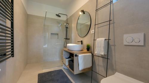 a bathroom with a sink and a mirror at Villa Amoroso by Villas Holiday in Nova Vas