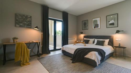 a bedroom with a large bed and a large window at Villa Amoroso by Villas Holiday in Nova Vas