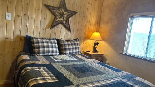 a bedroom with a bed with a star on the wall at Cuddle Up in Ruidoso
