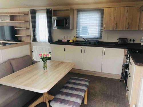a small kitchen with a table and a couch at Luxurious Lodging in Bembridge in Bembridge