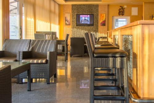 a row of chairs and tables in a restaurant at Motel Calypso Travnik in Travnik