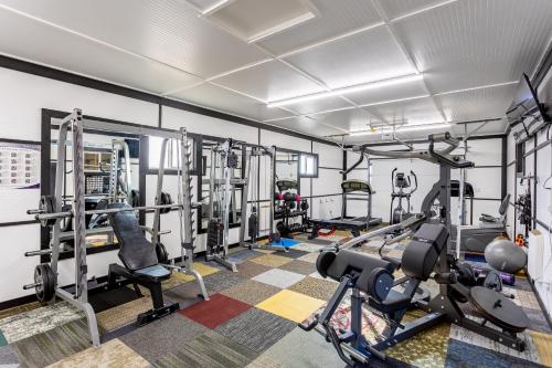 a gym with several treadmills and machines at Copperhead Lodge in Anaconda