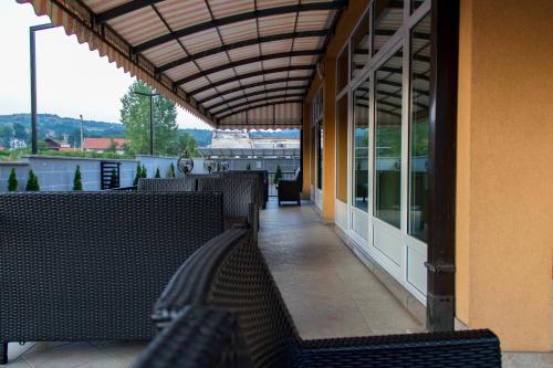 a balcony with benches and windows on a building at Motel Calypso Travnik in Travnik