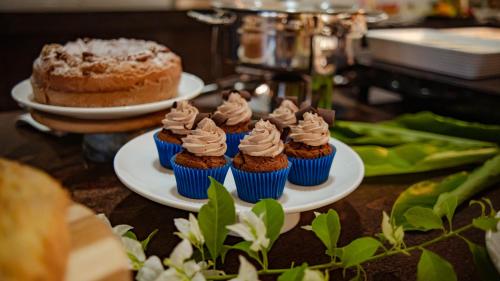 a group of cupcakes on plates on a table at Resende Imperial Hotel & Spa in Itacaré