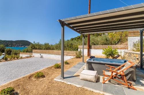 a picnic table and a bench under a canopy at Marani Home & Villas in Skopelos Town