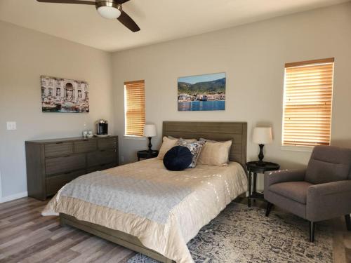 a bedroom with a bed and a chair at Fraser Family Vineyard Estate Pet-Friendly Home in Plymouth
