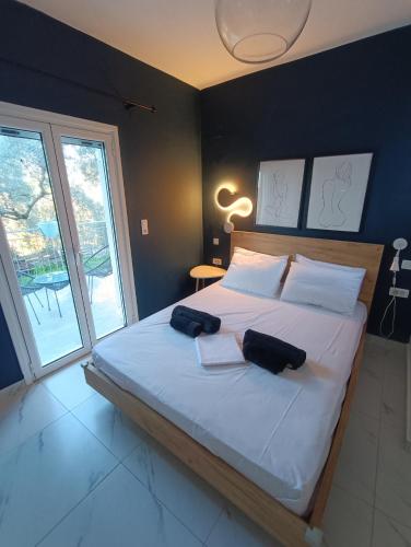 a bedroom with a large bed with two pillows on it at Alexander apartments in Spartià