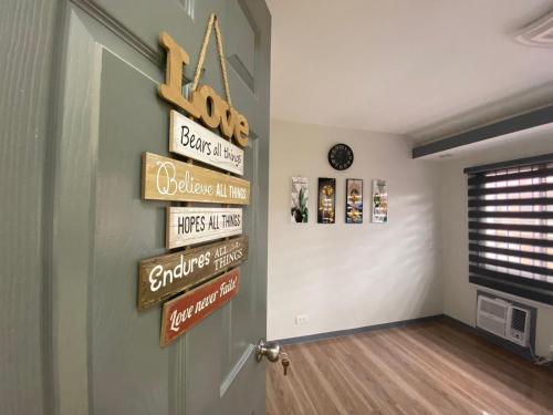 a room with a door with signs on the wall at Kege's Pad - 2 Bedroom Townhouse near Clark Airport & Aqua Planet - TRP8 in Mining