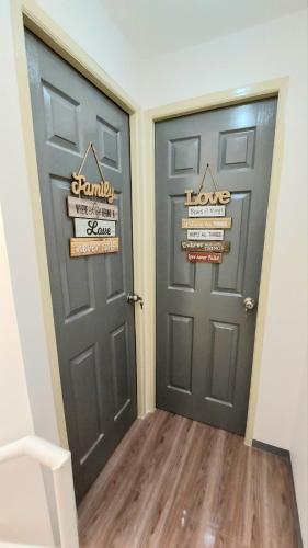 two doors with signs on them in a hallway at Kege's Pad - 2 Bedroom Townhouse near Clark Airport & Aqua Planet - TRP8 in Mining