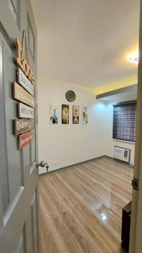 a living room with a wooden floor and a door at Kege's Pad - 2 Bedroom Townhouse near Clark Airport & Aqua Planet - TRP8 in Mining