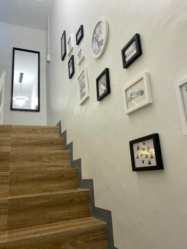 a stairway with pictures on the wall and a stair case at Kege's Pad - 2 Bedroom Townhouse near Clark Airport & Aqua Planet - TRP8 in Mining