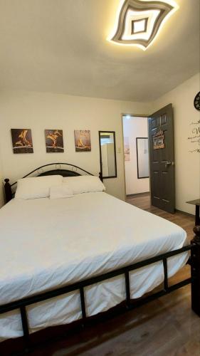 a bedroom with a large white bed in a room at Kege's Pad - 2 Bedroom Townhouse near Clark Airport & Aqua Planet - TRP8 in Mining