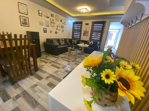 a living room with a vase of yellow flowers on a table at Kege's Pad - 2 Bedroom Townhouse near Clark Airport & Aqua Planet - TRP8 in Mining