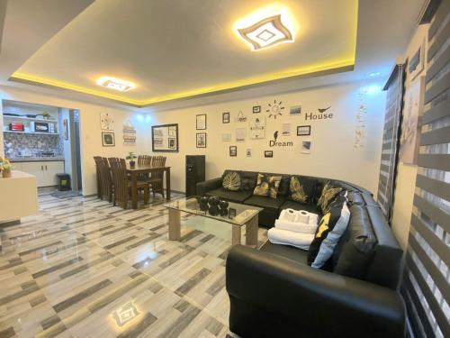 a living room with a leather couch and a table at Kege's Pad - 2 Bedroom Townhouse near Clark Airport & Aqua Planet - TRP8 in Mining