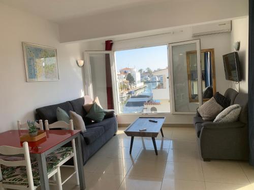 a living room with a couch and a table at Waterside Apartment - Two Bedroom in Empuriabrava