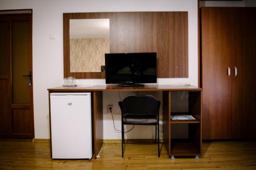 a desk with a computer and a chair in a room at Class in Petroşani