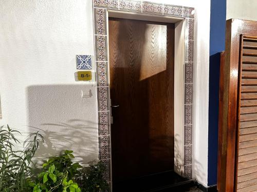 a brown door with a mirror on a wall at فلل الخالدية in Jeddah