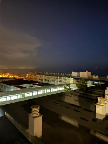 a view of a building at night at LUZ Y MAR in Matalascañas