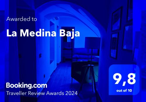 a poster for a hotel in a blue room at La Medina Baja in Setenil