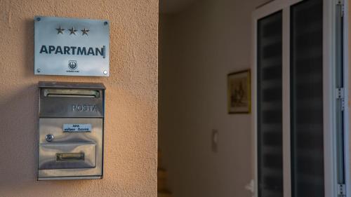 a parking meter on the side of a building at Apartmani Ana in Tivat