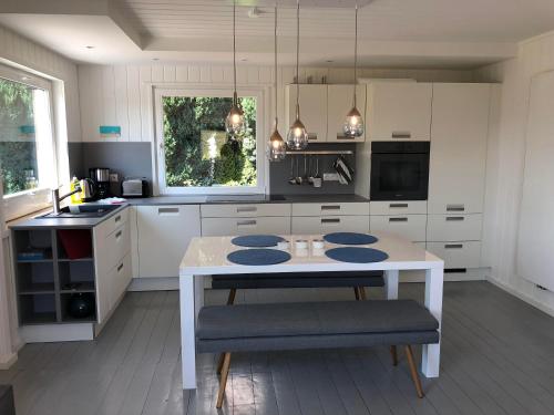 a kitchen with a white table and a white counter top at Ferienhaus am Hafen Zingst in Zingst