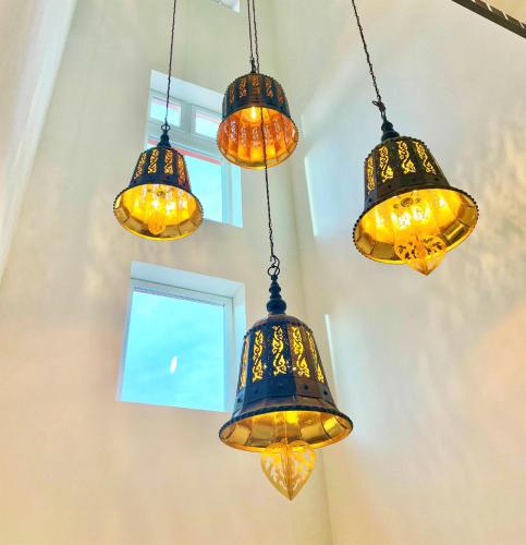 a group of lights hanging from a ceiling at living TIMELESS - Adler Apartments Sasbachwalden in Sasbachwalden