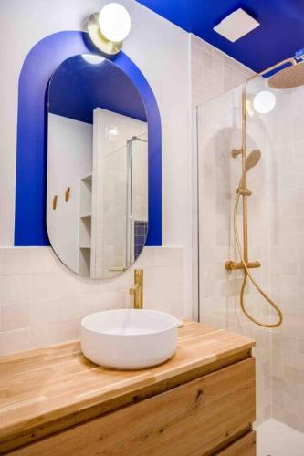 une salle de bain avec un lavabo et un miroir dans l'établissement ღ Le Majorelle • Au cœur du vieux port et cosy, à La Rochelle