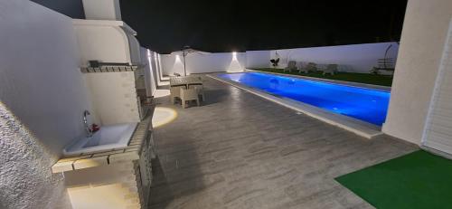 a large swimming pool in a room with at villa zak in Midoun