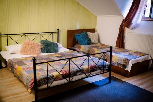 a bedroom with two beds and a chair at Class in Petroşani