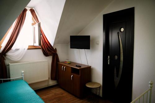 a bedroom with a door and a bed and a window at Class in Petroşani