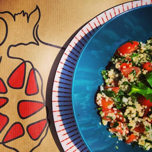 a blue plate with rice and vegetables on a table at Rodi Studios in Karavadhos