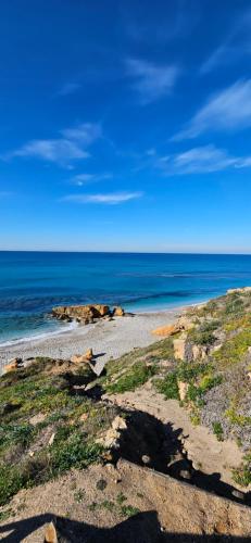 a beach with the ocean in the background at Guest House Canalis 17 in Oristano