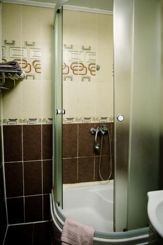 a shower with a glass door in a bathroom at Class in Petroşani