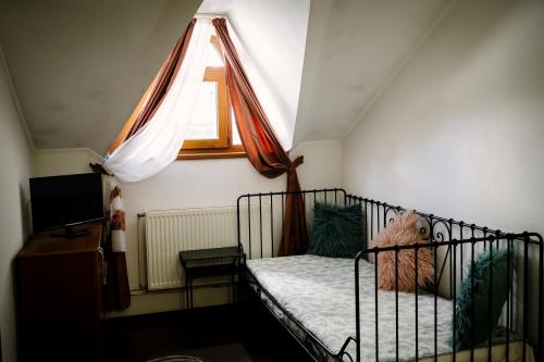 a small bedroom with a crib with a window at Class in Petroşani