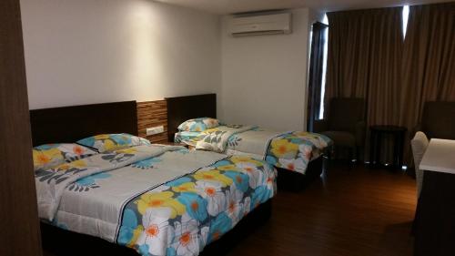 Ένα ή περισσότερα κρεβάτια σε δωμάτιο στο Kota Bharu Apartment