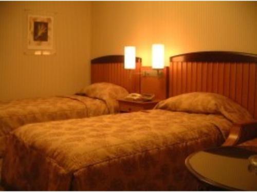 a hotel room with two beds and a table at Aeria Tohno - Vacation STAY 62233v in Tōno
