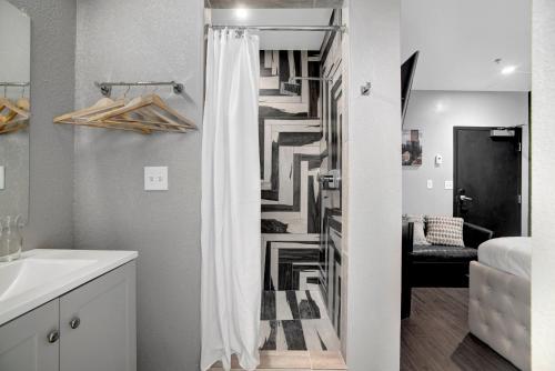 a bathroom with a staircase with a white shower curtain at Good Hotels Downtown Denver in Denver