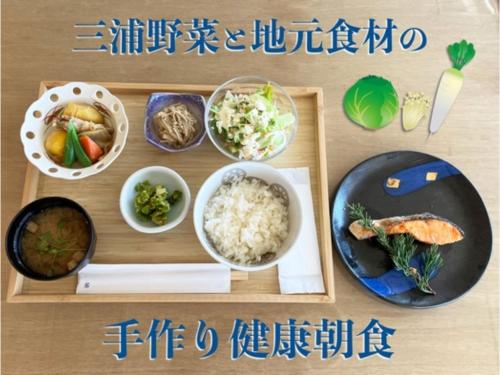 a wooden table with dishes of food on it at Shonan Relief - Vacation STAY 51630v in Yokosuka
