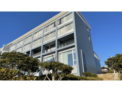 a large building with trees in front of it at Shonan Relief - Vacation STAY 51630v in Yokosuka