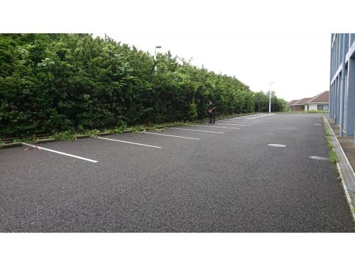 an empty parking lot with a person riding a bike at Shonan Relief - Vacation STAY 50852v in Yokosuka