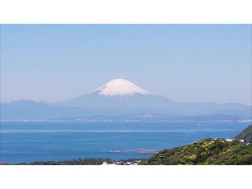 a mountain in the distance with the ocean in the foreground at Shonan Relief - Vacation STAY 50852v in Yokosuka