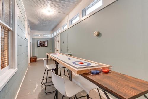 a room with a ping pong table and chairs at Baton Rouge Cottage with Fenced Yard Near Downtown! in Baton Rouge