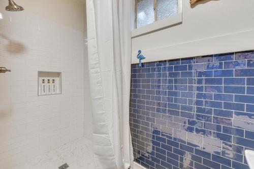 a bathroom with blue tile on the wall at Baton Rouge Cottage with Fenced Yard Near Downtown! in Baton Rouge