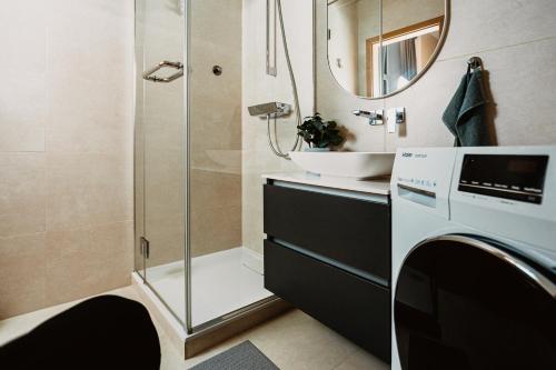 a bathroom with a shower and a sink at Stylish Central Apartment - 5 mins to Old Town in Rīga